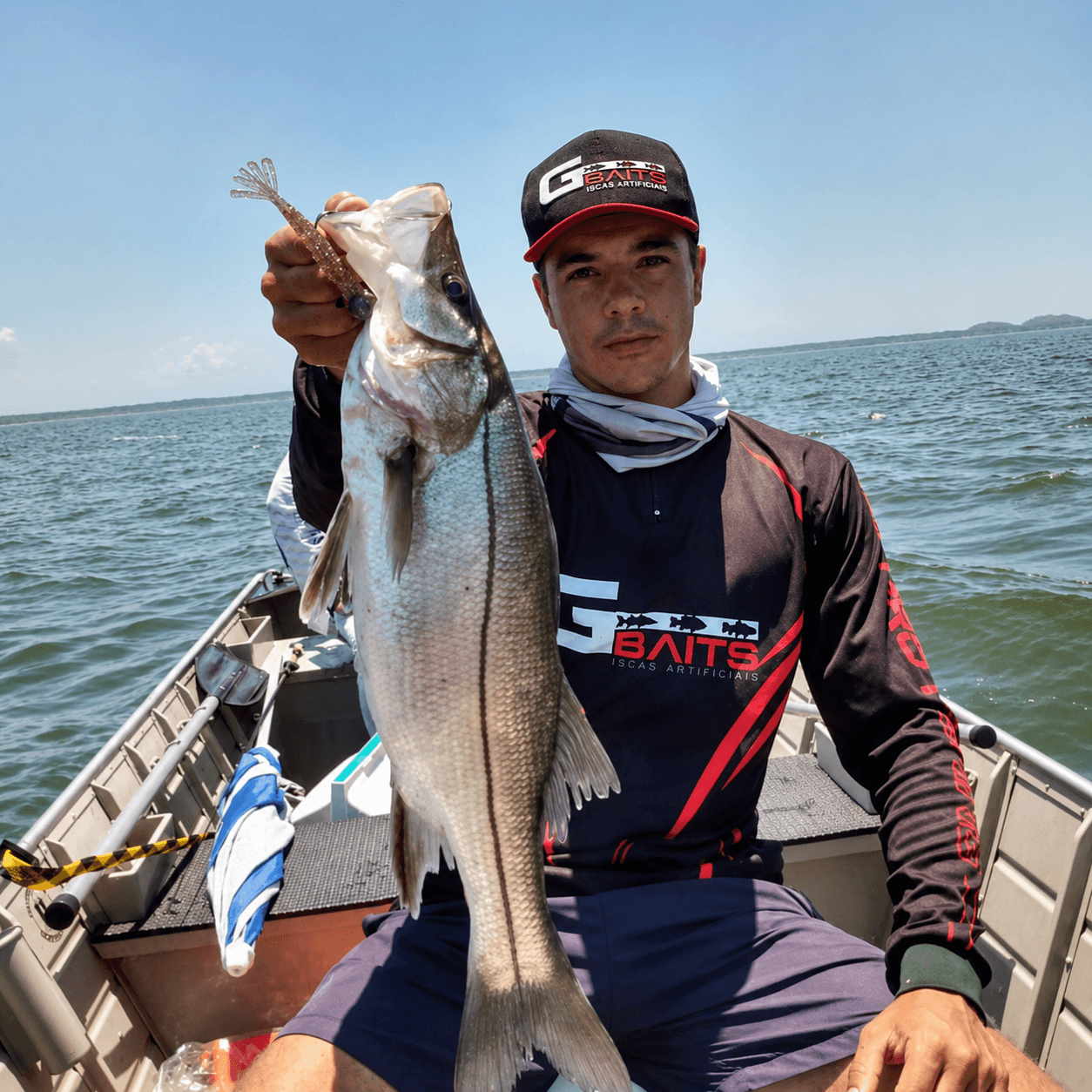 Pescador segurando um robalo fisgado com isca South Fishing